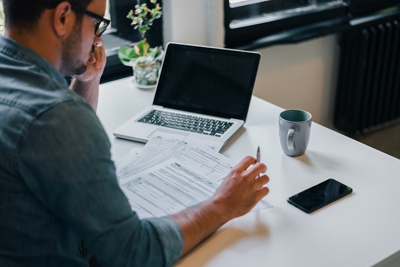 Man filing tax document